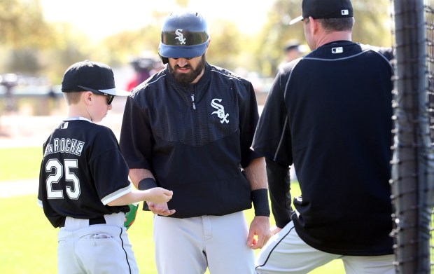 Drake LaRoche, son of White Sox first baseman Adam LaRoche, gives Adam Eaton some sunflower seeds during practice on Feb. 26, 2015 at spring training in Glendale, Ariz. (Brian Cassella/Chicago Tribune)