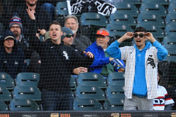 Two White Sox fans yell at Rangers first baseman Jake Burger after Burger loses his bat while swinging in the first inning at Rate Field on May 23, 2025, in Chicago. (John J. Kim/Chicago Tribune)