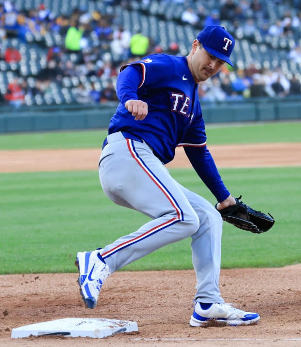 Rangers starting pitcher Tyler Mahle steps on first for an out against the White Sox in the first inning at Rate Field on May 23, 2025, in Chicago. (John J. Kim/Chicago Tribune)