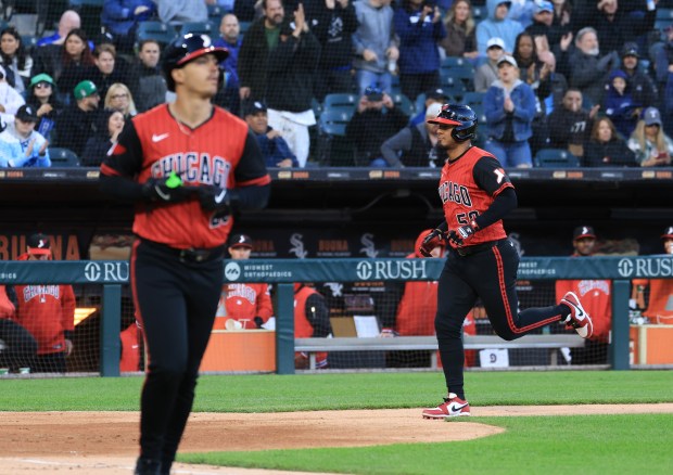 White Sox second baseman Lenyn Sosa (50) heads for home as first baseman Miguel Vargas (20) heads to first for a bases-loaded walk in the third inning against the Rangers at Rate Field on May 23, 2025, in Chicago. (John J. Kim/Chicago Tribune)