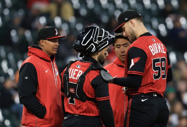 White Sox starting pitcher Sean Burke (59) is checked on by manager Will Venable, left, and a member of the training staff in the sixth inning against the Rangers at Rate Field on May 23, 2025, in Chicago. (John J. Kim/Chicago Tribune)