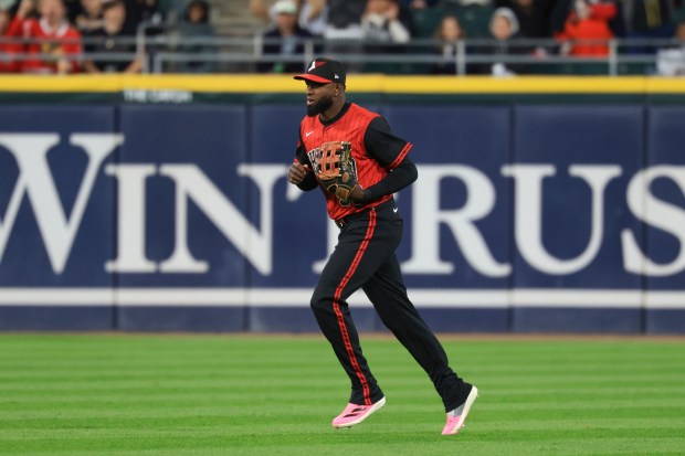 White Sox center fielder Luis Robert Jr. heads to the dugout after throwing out Rangers third baseman Josh Jung at the plate in the sixth inning at Rate Field on May 23, 2025, in Chicago. (John J. Kim/Chicago Tribune)