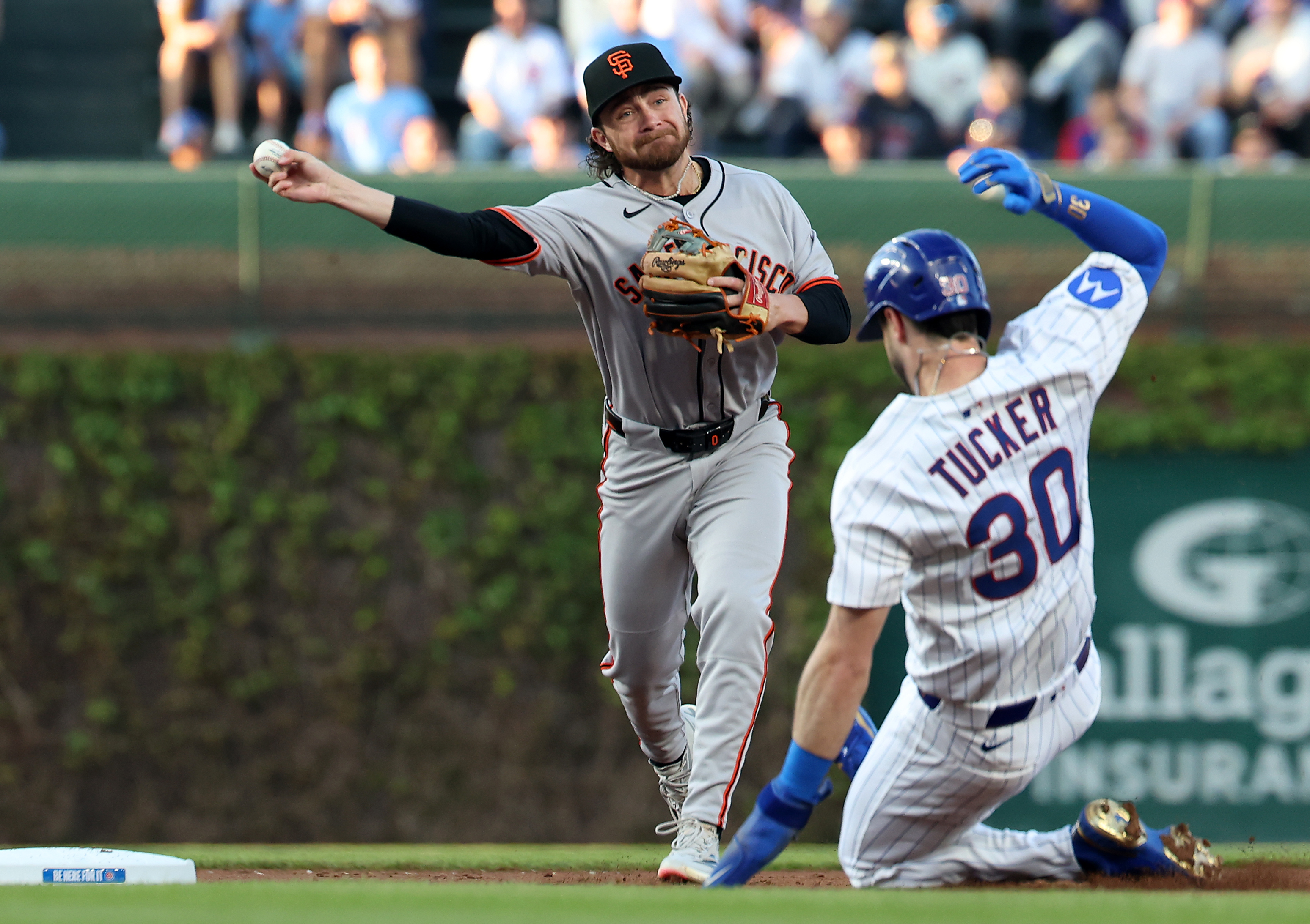 Chicago Cubs outfielder Kyle Tucker (30) is forced out at second base as San Francisco Giants second baseman Brett Wisely (0) completes a double play after a ground ball hit by Chicago Cubs designated hitter Seiya Suzuki in the first inning of a game at Wrigley Field in Chicago on May 6, 2025. (Chris Sweda/Chicago Tribune)