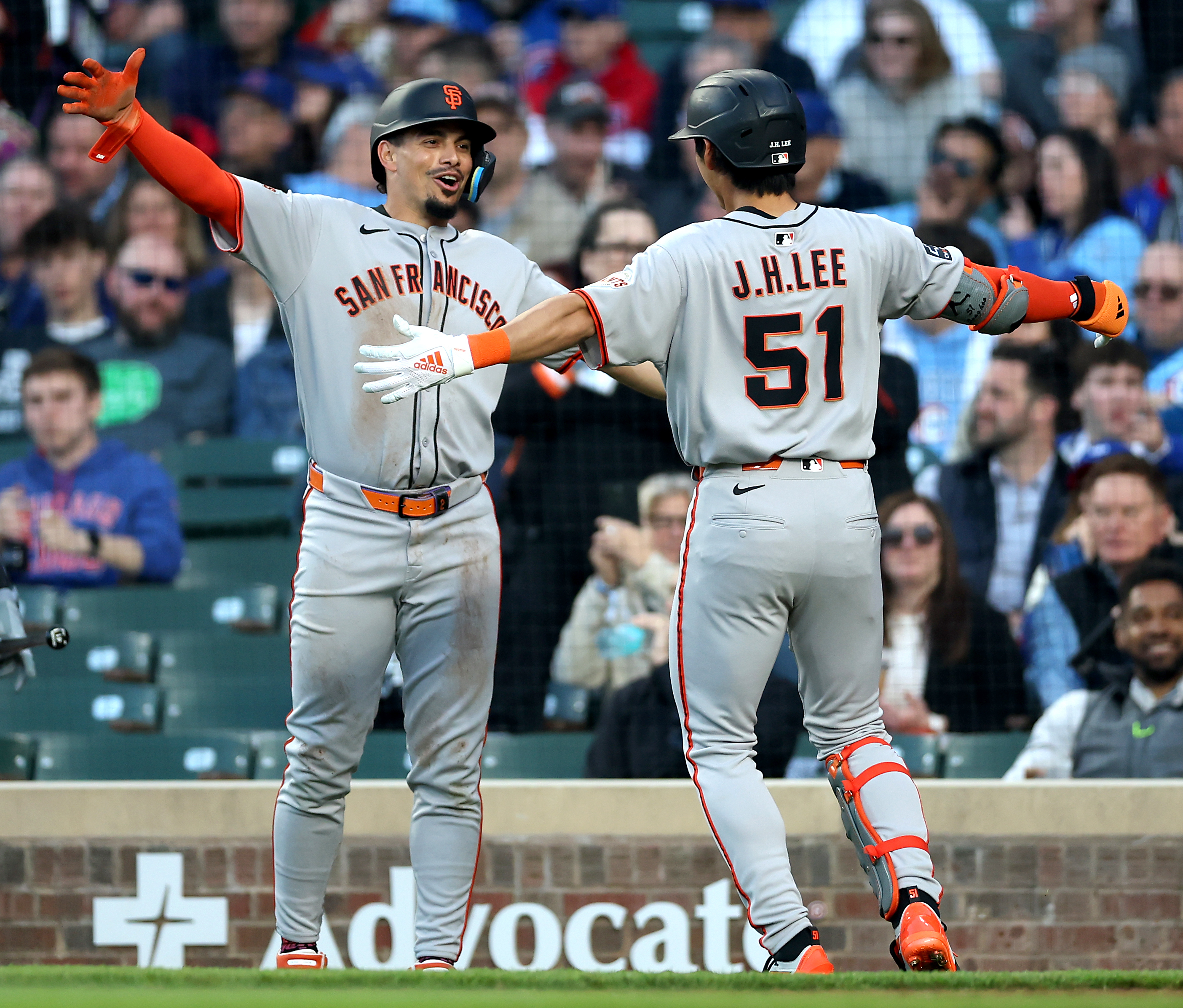 San Francisco Giants outfielder Jung Hoo Lee (51) is congratulated by teammate Willy Adames (left) after hitting a 2-run home run in the third inning of a game against the Chicago Cubs at Wrigley Field in Chicago on May 6, 2025. (Chris Sweda/Chicago Tribune)