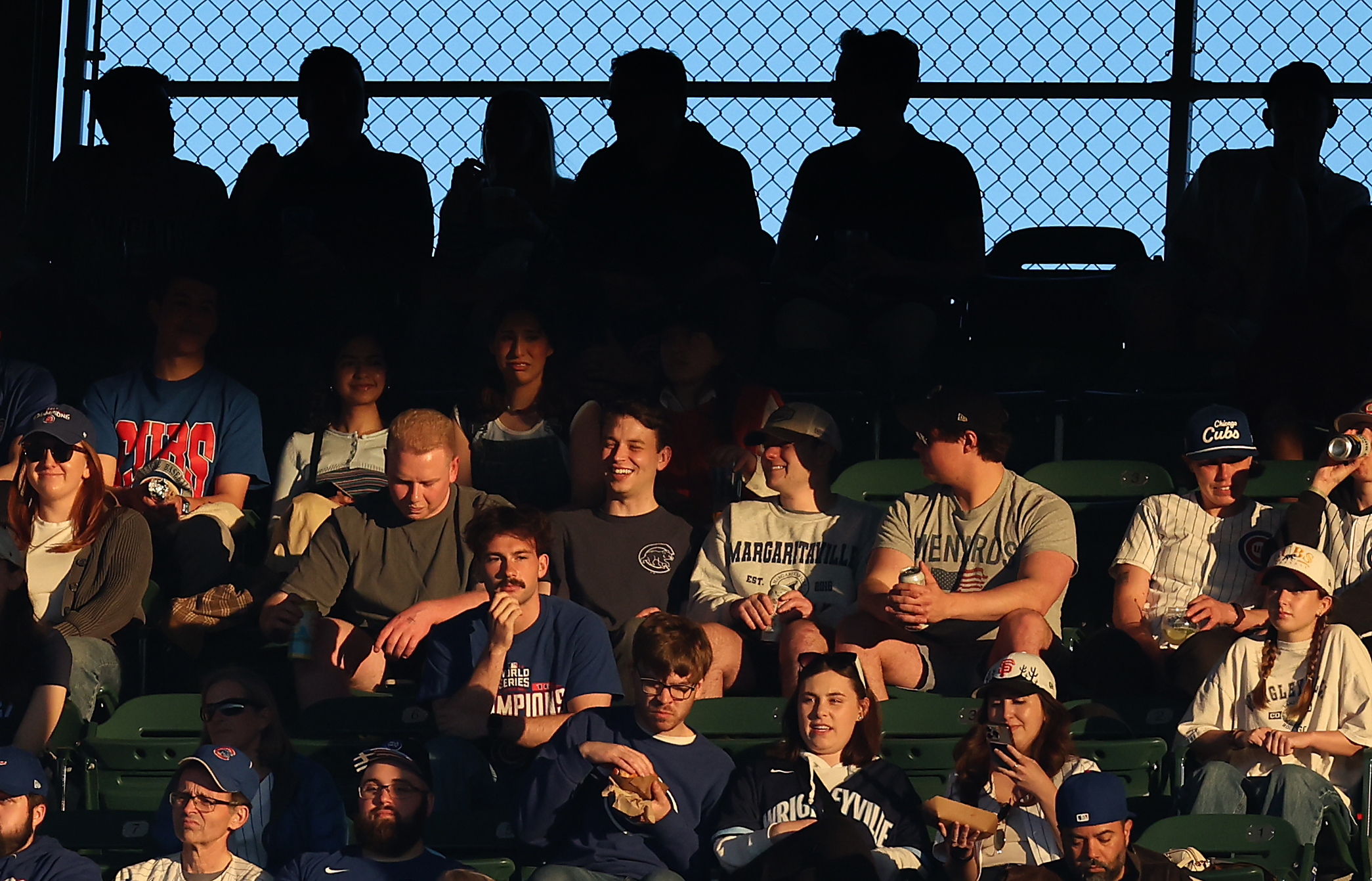 The last bit of sunlight for the day shines on fans in the upper deck in the third inning of a game between the Chicago Cubs and the San Francisco Giants at Wrigley Field in Chicago on May 6, 2025. (Chris Sweda/Chicago Tribune)