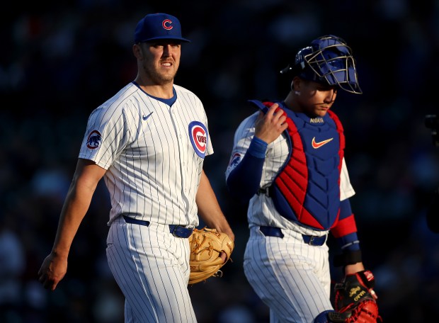 Cubs starter Jameson Taillon and catcher Miguel Amaya walk to the dugout after finishing off the Marlins in the second inning on May 14, 2025, at Wrigley Field. (Chris Sweda/Chicago Tribune)