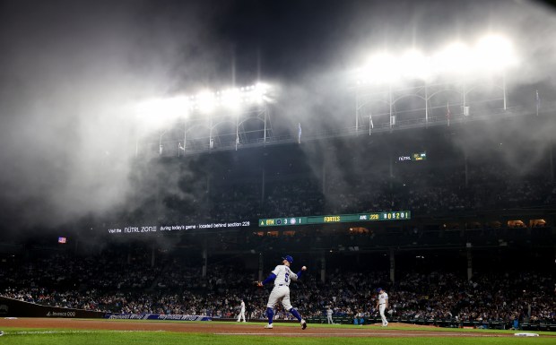 With heavy fog blanketing the area, Chicago Cubs third baseman Jon Berti (5) takes infield practice before the start of the eighth inning of a game against the Miami Marlins at Wrigley Field in Chicago on May 14, 2025. (Chris Sweda/Chicago Tribune)