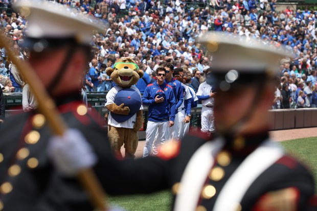 Chicago Cubs manager Craig Counsell and his team stand as a U.S. Marine Corps color guard stands for the national anthem before a Memorial Day game between the Cubs and the Colorado Rockies at Wrigley Field in Chicago on May 26, 2025. (Chris Sweda/Chicago Tribune)