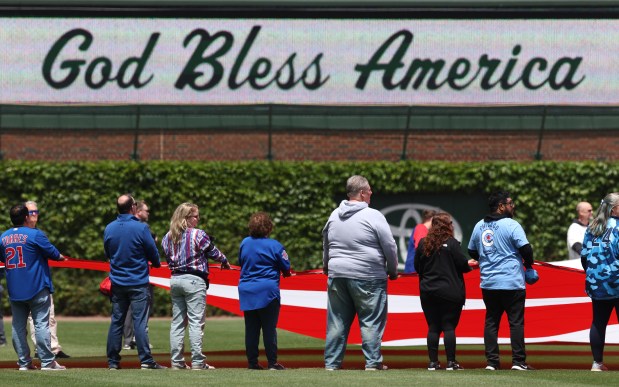 A U.S. flag is displayed on the field to commemorate Memorial Day as God Bless America is performed prior to a game between the Chicago Cubs and the Colorado Rockies at Wrigley Field in Chicago on May 26, 2025. (Chris Sweda/Chicago Tribune)