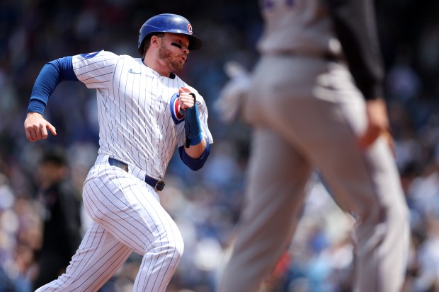 Chicago Cubs outfielder Ian Happ advances to third base on a double by teammate Seiya Suzuki in the first inning of a game against the Colorado Rockies at Wrigley Field in Chicago on May 26, 2025. (Chris Sweda/Chicago Tribune)