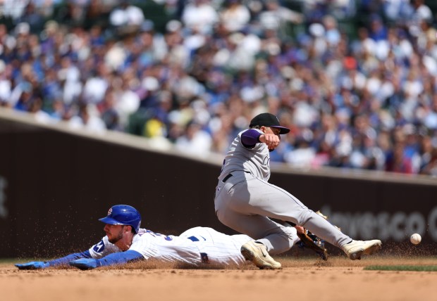 Chicago Cubs outfielder Kyle Tucker steals second base as Colorado Rockies second baseman Kyle Farmer takes a late throw in the fifth inning of a game at Wrigley Field in Chicago on May 26, 2025. (Chris Sweda/Chicago Tribune)
