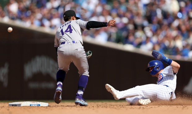 Chicago Cubs baserunner Matt Shaw slides in safely at second base as Colorado Rockies shortstop Ezequiel Tovar (14) is unable to handle an errant throw in the seventh inning of a game at Wrigley Field in Chicago on May 26, 2025. (Chris Sweda/Chicago Tribune)