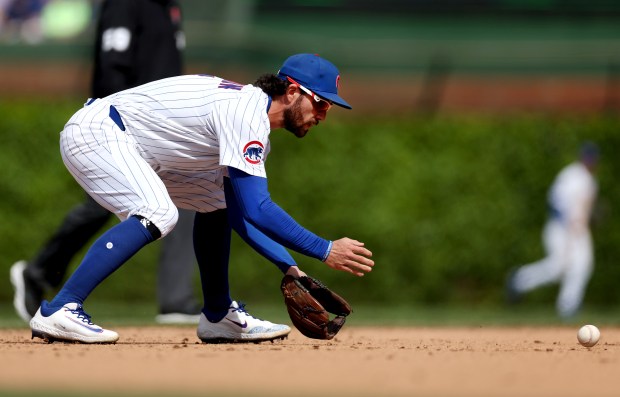 Chicago Cubs shortstop Dansby Swanson fields a ground ball in the ninth inning of a game against the Colorado Rockies at Wrigley Field in Chicago on May 26, 2025. (Chris Sweda/Chicago Tribune)