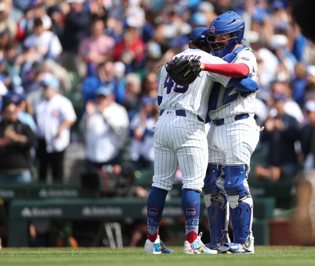 Chicago Cubs relief pitcher Daniel Palencia (left) and catcher Reese McGuire celebrate after closing out the Colorado Rockies for a victory at Wrigley Field in Chicago on May 26, 2025. (Chris Sweda/Chicago Tribune)
