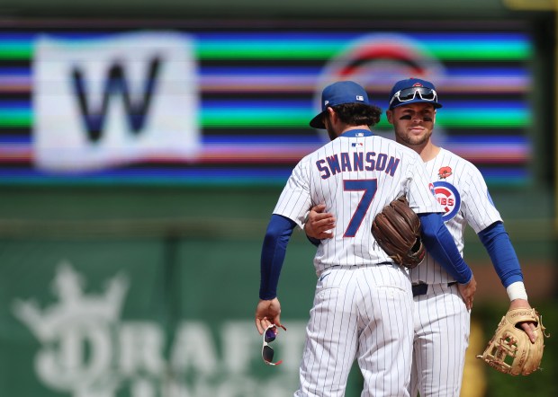 Chicago Cubs shortstop Dansby Swanson (7) and second baseman Nico Hoerner celebrate after a victory over the Colorado Rockies at Wrigley Field in Chicago on May 26, 2025. (Chris Sweda/Chicago Tribune)