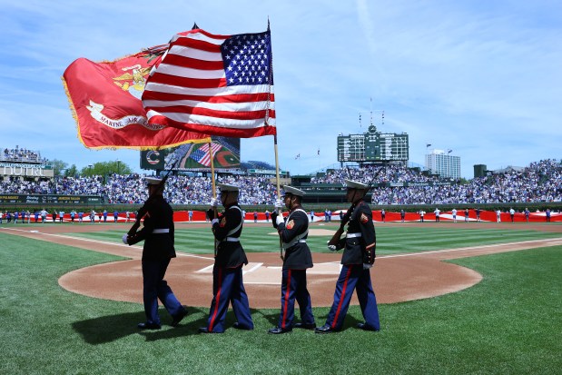 A U.S. Marine Corps color guard walks off the field after a Memorial Day pregame ceremony before a game between the Chicago Cubs and the Colorado Rockies at Wrigley Field in Chicago on May 26, 2025. (Chris Sweda/Chicago Tribune)