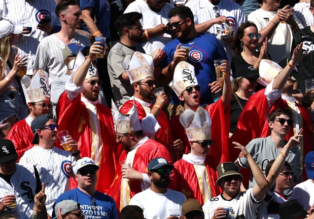 White Sox fans dressed in pope outfits sing during the seventh-inning stretch as the Sox take on the Cubs on May 16, 2025, at Wrigley Field. (Chris Sweda/Chicago Tribune)
