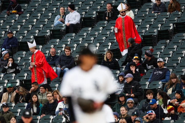 Two fans dressed as Pope Leo XIV walk through the stands while the Chicago White Sox play the Seattle Mariners during the third inning at Rate Field on Monday, May 19, 2025, in Chicago. (Armando L. Sanchez/Chicago Tribune)