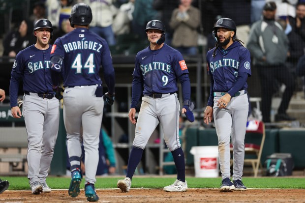 Seattle Mariners catcher Mitch Garver (18), Seattle Mariners third baseman Ben Williamson (9), and Seattle Mariners shortstop J.P. Crawford (3) celebrate with Seattle Mariners outfielder Julio Rodríguez (44) after Rodríguez hit a grand slam during the eighth inning against the Chicago White Sox at Rate Field on Monday, May 19, 2025, in Chicago. (Armando L. Sanchez/Chicago Tribune)