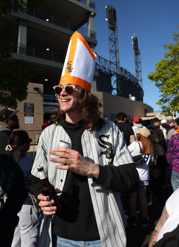Patrick Feltz (cq), 28, of Villa Park, sports his homemade pope hat while waiting to enter Rate Field in Chicago for a baseball game between the Chicago White Sox and the Miami Marlins on May 10, 2025. Formerly Cardinal Robert Francis Prevost, the new Pope Leo XIV was born and raised in the Chicagoland area. It took Feltz 15 minutes to make the pope hat by following instructions from a Youtube video. (Chris Sweda/Chicago Tribune)