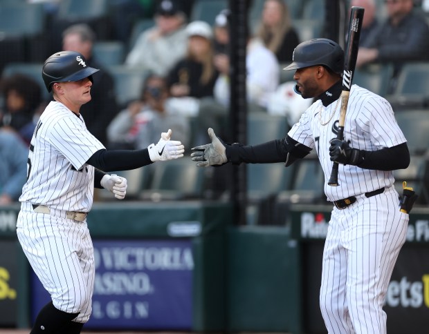 Chicago White Sox designated hitter Andrew Vaughn is congratulated by teammate Joshua Palacios (right) after Vaughn hit a solo home run in the first inning of a game against the Miami Marlins at Rate Field in Chicago on May 10, 2025. (Chris Sweda/Chicago Tribune)