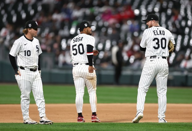 White Sox players Chase Meidroth (10), Lenyn Sosa (50) and Tim Elko stand on the field during a break in the action in the eighth inning against the Marlins on May 10, 2025, at Rate Field. (Chris Sweda/Chicago Tribune)