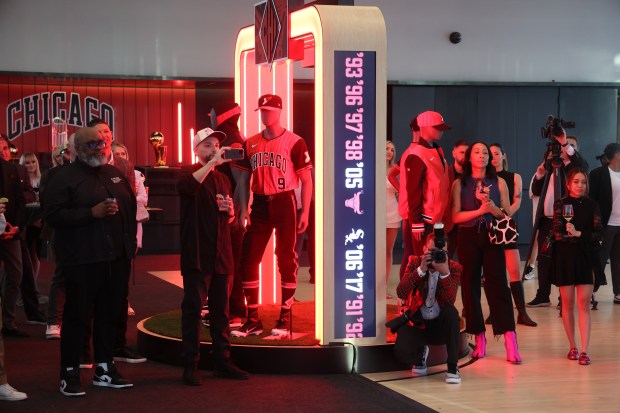 People gather at the event space 167 Events in Chicago as the Chicago White Sox unveil new Nike City Connect Series uniforms on Monday, April 28, 2025. The uniform has the Chicago Bulls logo across the chest. (Terrence Antonio James/Chicago Tribune)