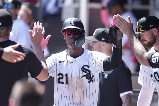 Michael A. Taylor #21 of the Chicago White Sox celebrates scoring with teammates in the dugout during the third inning against the Miami Marlins at Rate Field on May 11, 2025 in Chicago, Illinois. (Photo by Geoff Stellfox/Getty Images)
