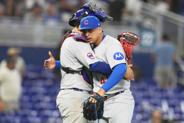 Reliever Daniel Palencia, right, hugs catcher Miguel Amaya after the Cubs defeated the Marlins 2-1 on May 21, 2025, in Miami. (Lynne Sladky/AP)