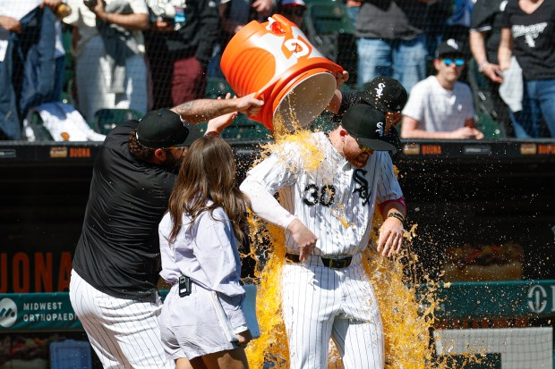 Chicago White Sox's Tim Elko, front right, is doused by teammates after a baseball game against the Miami Marlins, Sunday, May 11, 2025, in Chicago. (AP Photo/Kamil Krzaczynski)