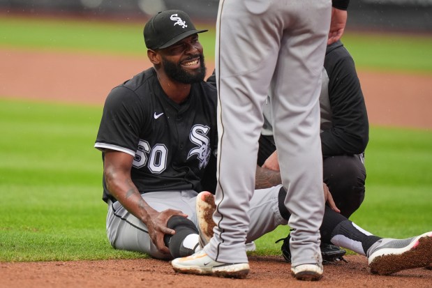 Teammates check on White Sox reliever Miguel Castro after he suffered a right knee injury during the ninth inning against the Mets on May 28, 2025, in New York. Castro exited the game. (Frank Franklin II/AP)
