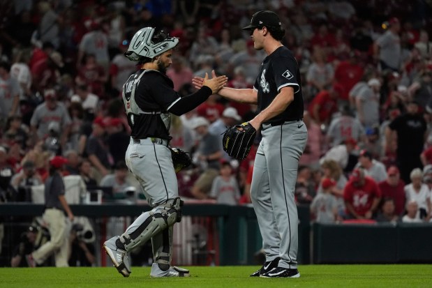 White Sox catcher Edgar Quero, left, and reliever Mike Vasil celebrate a win against the Reds on May 14, 2025, in Cincinnati. (Carolyn Kaster/AP)