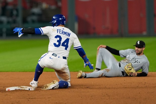 Kansas City Royals' Freddy Fermin (34) advances safely to second on a single by Jonathan India during the ninth inning of a baseball game against the Chicago White Sox, Tuesday, May 6, 2025, in Kansas City, Mo. (AP Photo/Charlie Riedel)