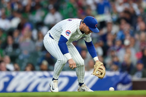 Chicago Cubs second base Nico Hoerner (2) misses a ball from Miami Marlins outfielder Javier Sanoja (46) resulting in a run during the fifth inning at Wrigley Field Tuesday May 13, 2025, in Chicago. (Armando L. Sanchez/Chicago Tribune)