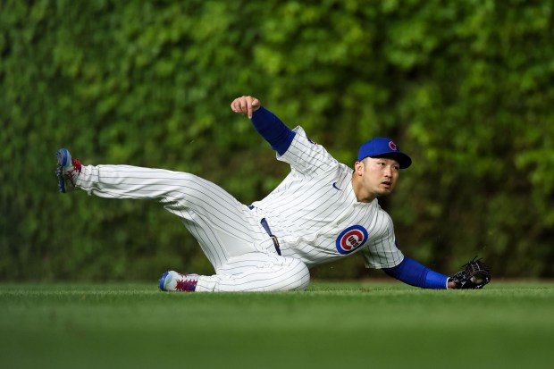 Chicago Cubs outfielder Seiya Suzuki (27) catches a ball from Miami Marlins outfielder Javier Sanoja (46) during the seventh inning at Wrigley Field Tuesday May 13, 2025, in Chicago. (Armando L. Sanchez/Chicago Tribune)