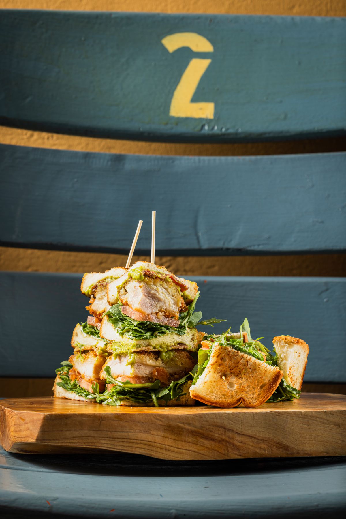 A fried chicken sandwich on a wooden board at Dodger Stadium.