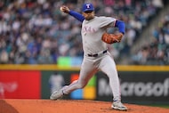 Texas Rangers starting pitcher Kumar Rocker throws against the Seattle Mariners during the...