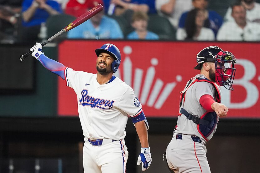 Texas Rangers second baseman Marcus Semien reacts next to Boston Red Sox catcher Connor Wong...