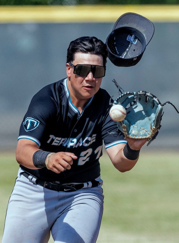 Grand Terrace’s Jesse Medina #21 fields a high hopper and...