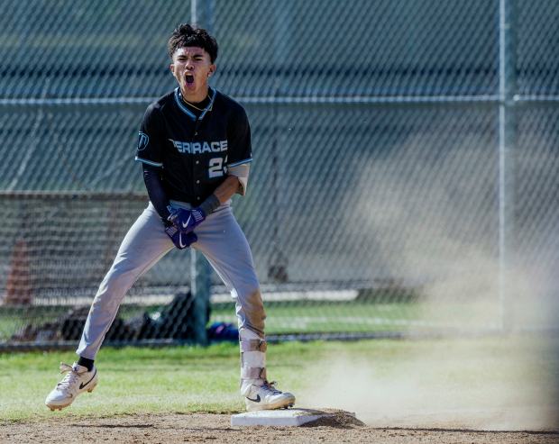 Grand Terrace’s Ray Roybal #23 celebrates his triple against Chino...