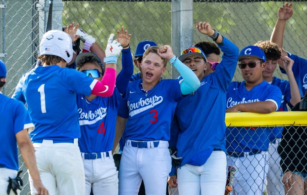 Chino’s Grant Kuhns-Vasquez #1 is greeted in the dugout after...