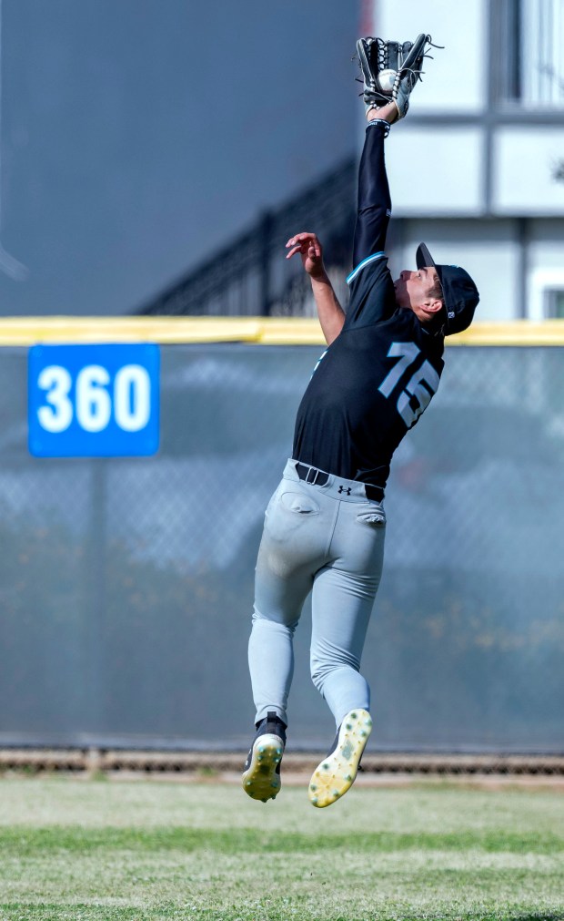 Grand Terrace’s Ezekiel Jahen #15 makes a leaping catch of...
