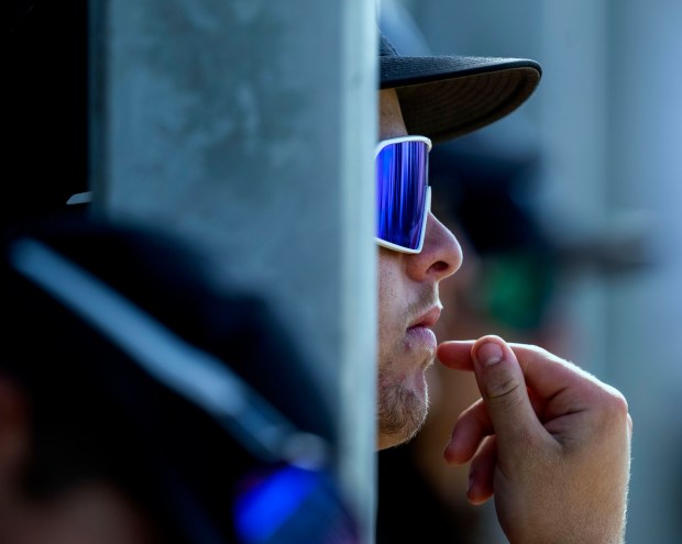 A Grand Terrace player watches the game from the dugout...