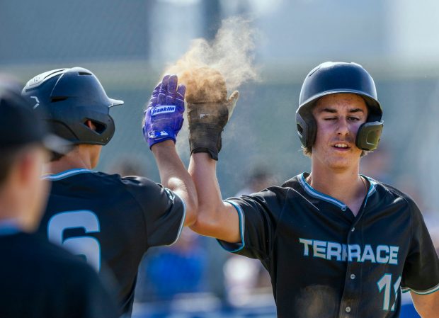 Grand Terrace’s Vasili Kazaltzes #11, right high fives Grand Terrace’s...