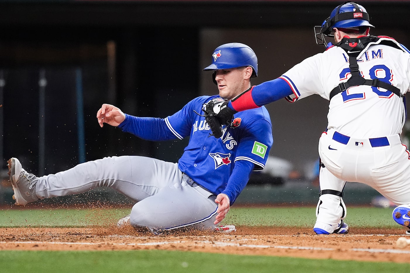 Toronto Blue Jays outfielder Daulton Varsho is out at home on a tag from Texas Rangers...