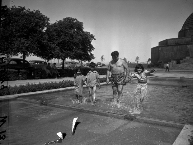 Helen, 6, Robert, 8, and Julia Chavez, 10, wade in...