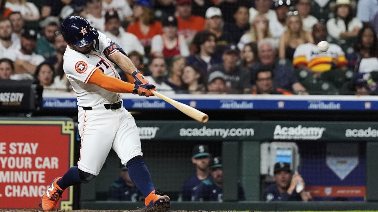 Houston Astros' Jose Altuve hits a home run during the fifth inning of a baseball game against the Seattle Mariners in Houston, Thursday, May 22, 2025. (AP Photo/Ashley Landis)
