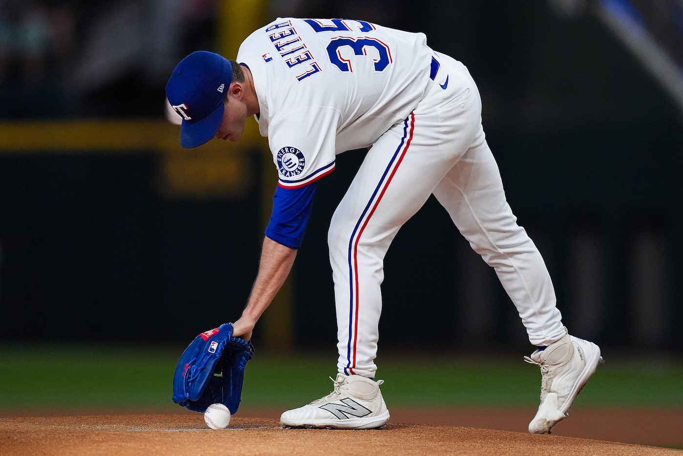 Texas Rangers pitcher Jack Leiter grabs the ball as he takes the mound for the first inning...