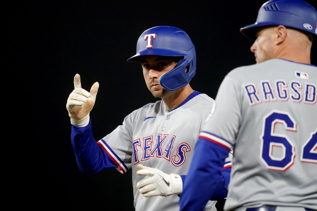 Kyle Higashioka gestures to the dugout after hitting a single during a game earlier this season.