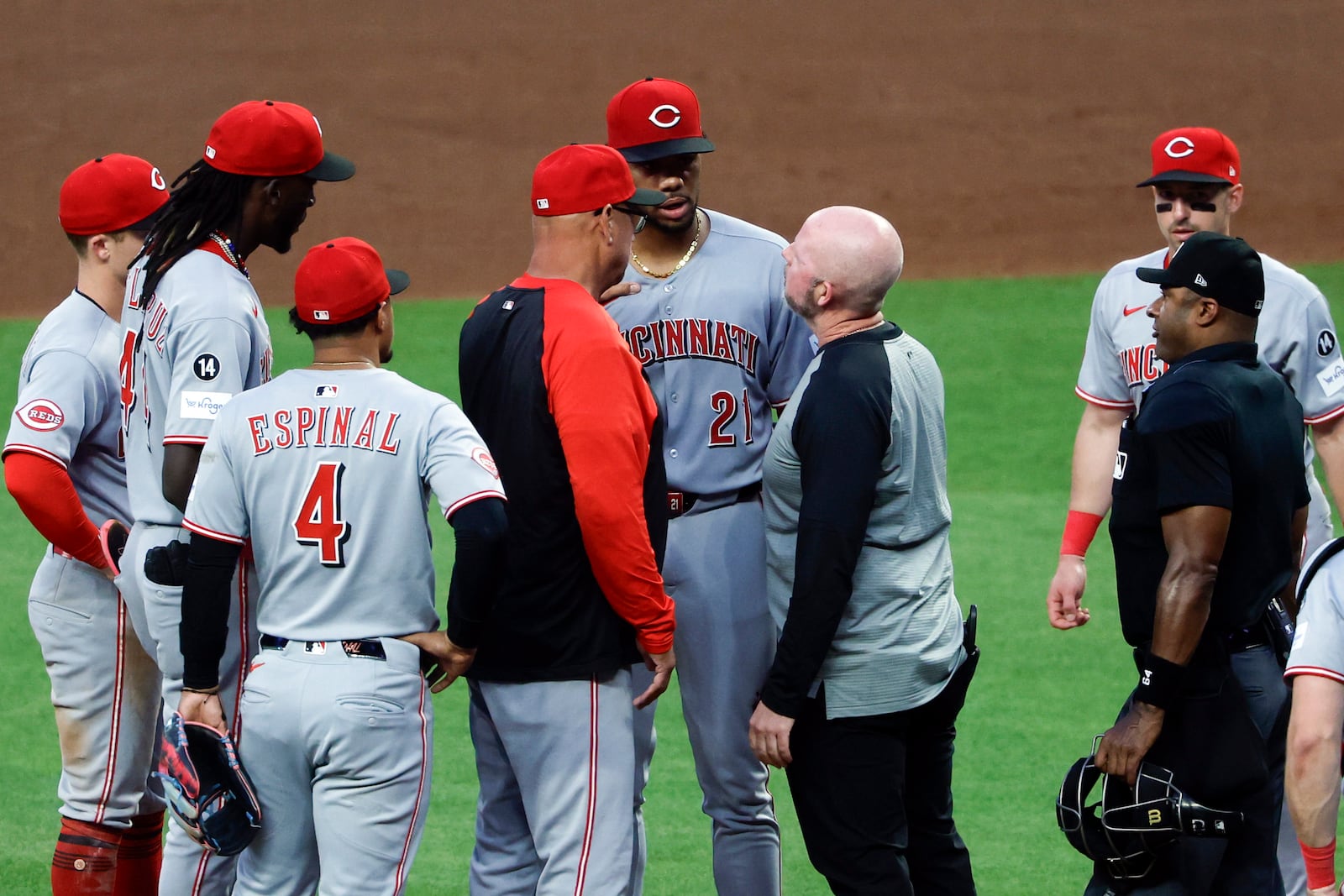 Cincinnati Reds pitcher Hunter Greene (21) is tended to after sustaining an injury while warming up during the fourth inning of a baseball game against the Atlanta Braves, Wednesday, May 7, 2025, in Atlanta. (AP Photo/Butch Dill)